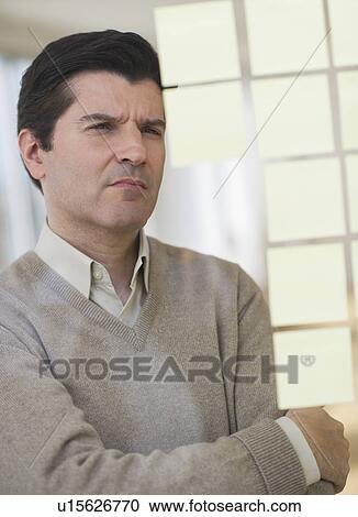 Stock Image - USA, New Jersey, Jersey City, Businessman observing adhesive notes on window. Fotosearch