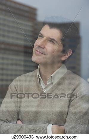 USA, New Jersey, Jersey City, Businessman looking through window View Large Photo Image Stock Image - USA, New Jersey, Jersey City, Businessman looking through window. Fotosearch