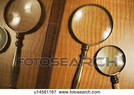 Stock Photo - USA, New Jersey, Jersey City, Two magnifying glasses reflected in mirror. Fotosearch