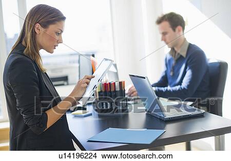 USA, New Jersey, Jersey City, Two young people in office View Large Photo Image Picture - USA, New Jersey, Jersey City, Two young people in office. Fotosearch