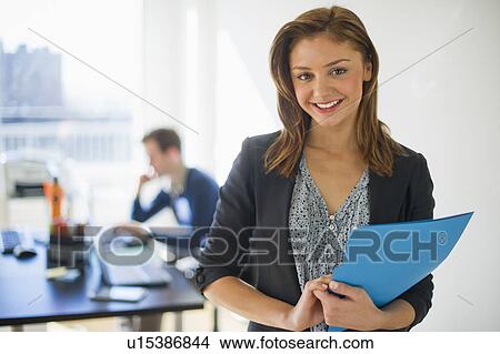 USA, New Jersey, Jersey City, Two young people in office View Large Photo Image Picture - USA, New Jersey, Jersey City, Two young people in office. Fotosearch