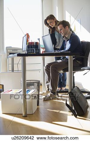 USA, New Jersey, Jersey City, Two young people in office View Large Photo Image Stock Image - USA, New Jersey, Jersey City, Two young people in office. Fotosearch