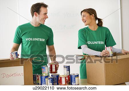 Stock Image - USA, New Jersey, Jersey City, Two young people as volunteers. Fotosearch