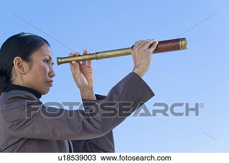 USA, New Jersey, Jersey City, Woman looking through telescope View Large Photo Image Stock Image - USA, New Jersey, Jersey City, Woman looking through telescope. Fotosearch
