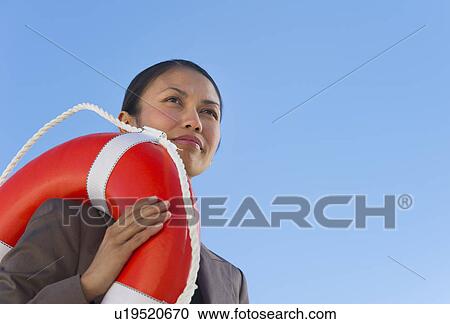 USA, New Jersey, Jersey City, Woman carrying life belt View Large Photo Image Stock Image - USA, New Jersey, Jersey City, Woman carrying life belt. Fotosearch