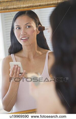 USA, New Jersey, Jersey City, Woman applying makeup in mirror View Large Photo Image Stock Image - USA, New Jersey, Jersey City, Woman applying makeup in mirror. Fotosearch