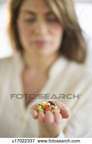 USA, New Jersey, Jersey City, Woman holding pills View Large Photo Image Stock Photo - USA, New Jersey, Jersey City, Woman holding pills. Fotosearch