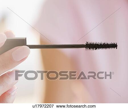 Stock Photo - USA, New Jersey, Jersey City, Woman hand holding brush for painting eyelids. Fotosearch