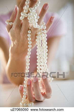 USA, New Jersey, Jersey City, Woman's hand holding pearl beads View Large Photo Image Stock Image - USA, New Jersey, Jersey City, Woman's hand holding pearl beads. Fotosearch