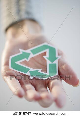 Stock Photo - USA, New Jersey, Jersey City, Woman's hand holding recycling symbol. Fotosearch