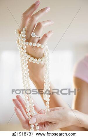 USA, New Jersey, Jersey City, Woman's hand holding pearl beads View Large Photo Image Stock Photo - USA, New Jersey, Jersey City, Woman's hand holding pearl beads. Fotosearch