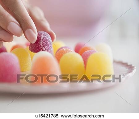 USA, New Jersey, Jersey City, Woman's hand eating jellies View Large Photo Image Stock Photography - USA, New Jersey, Jersey City, Woman's hand eating jellies. Fotosearch