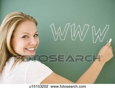 Stock Image - USA, New Jersey, Jersey City, Young attractive woman writing www on blackboard. Fotosearch