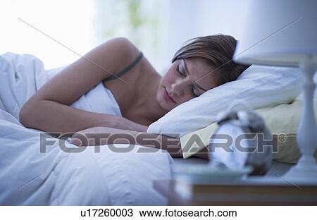 USA, New Jersey, Jersey City, Young woman sleeping in bed View Large Photo Image Stock Image - USA, New Jersey, Jersey City, Young woman sleeping in bed. Fotosearch