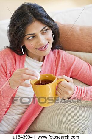 USA, New Jersey, Jersey City, Young attractive woman drinking tea from yellow cup View Large Photo Image Stock Image - USA, New Jersey, Jersey City, Young attractive woman drinking tea from yellow cup. Fotosearch