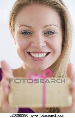 USA, New Jersey, Jersey City, Young attractive woman holding gift View Large Photo Image Stock Image - USA, New Jersey, Jersey City, Young attractive woman holding gift. Fotosearch