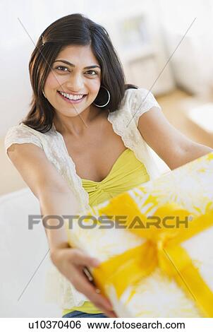 Stock Photograph - USA, New Jersey, Jersey City, Young attractive woman showing gift. Fotosearch