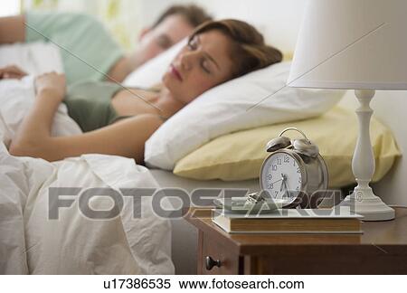 USA, New Jersey, Jersey City, Young couple sleeping in bed View Large Photo Image Stock Photography - USA, New Jersey, Jersey City, Young couple sleeping in bed. Fotosearch