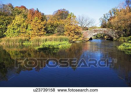 Stock Photo - USA, New York City, Central Park lake and footbridge. Fotosearch