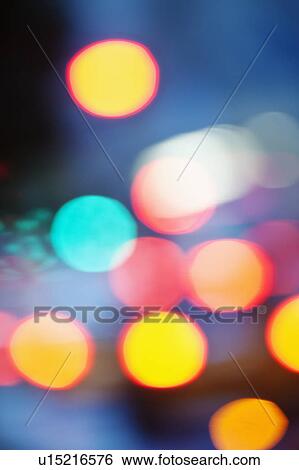 Stock Photograph - USA, New York City, City lights out of focus. Fotosearch