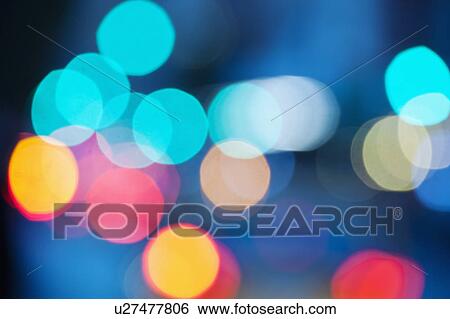 Stock Photograph - USA, New York City, City lights out of focus. Fotosearch