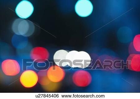 Stock Photograph - USA, New York City, City lights out of focus. Fotosearch