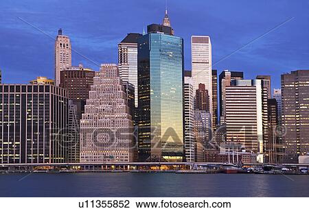 Stock Image - USA, New York City, Manhattan skyline at dusk. Fotosearch