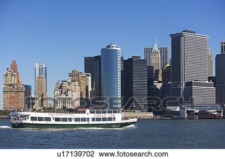 Stock Image - USA, New York City, Manhattan skyline with ferry. Fotosearch