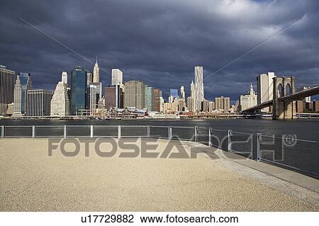 Stock Image - USA, New York City, Manhattan skyline with Brooklyn Bridge. Fotosearch