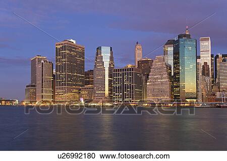 Stock Image - USA, New York City, Manhattan skyline at dusk. Fotosearch