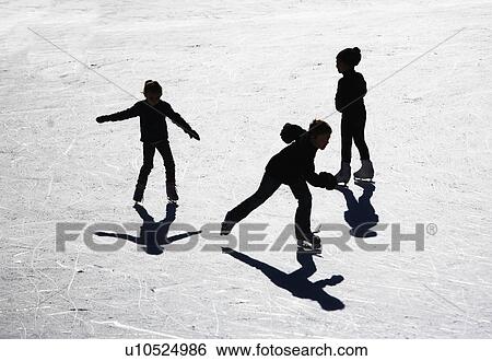 Stock Photograph - USA, New York City, people ice skating in Central Park. Fotosearch