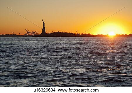 USA, New York City, Staten Island, Harbor and silhouette of Statue of Liberty in background View Large Photo Image Picture - USA, New York City, Staten Island, Harbor and silhouette of Statue of Liberty in background. Fotosearch