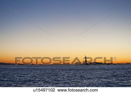 USA, New York City, Staten Island, Harbor and silhouette of Statue of Liberty in background View Large Photo Image Stock Image - USA, New York City, Staten Island, Harbor and silhouette of Statue of Liberty in background. Fotosearch