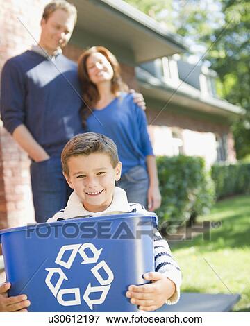 USA, New York, Flanders, Boy (8-9) holding bucket with recycling symbol, parents in background View Large Photo Image Stock Photo - USA, New York, Flanders, Boy (8-9) holding bucket with recycling symbol, parents in background. Fotosearch