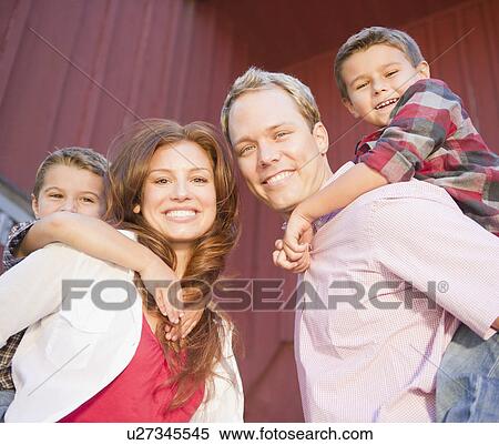 Stock Photography - USA, New York, Flanders, Couple with two boys (4-5, 8-9) portrait. Fotosearch