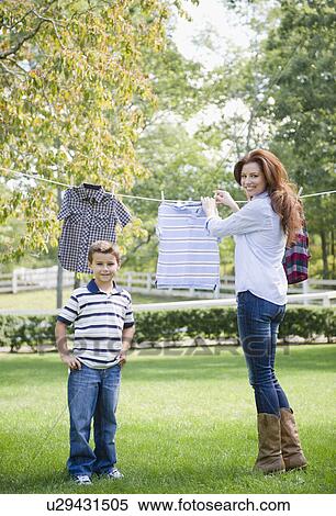 USA, New York, Flanders, Mother and son (8-9) doing laundry View Large Photo Image Stock Photography - USA, New York, Flanders, Mother and son (8-9) doing laundry. Fotosearch