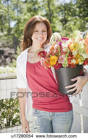USA, New York, Flanders, Portrait of woman with bunch of flowers View Large Photo Image Picture - USA, New York, Flanders, Portrait of woman with bunch of flowers. Fotosearch