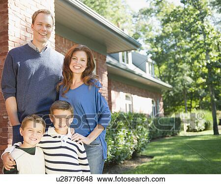 Stock Photo - USA, New York, Flanders, Portrait of family with two boys (4-5, 8-9). Fotosearch