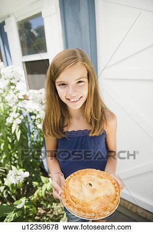 USA, New York, Girl (10-11) holding apple pie View Large Photo Image Stock Photo - USA, New York, Girl (10-11) holding apple pie. Fotosearch
