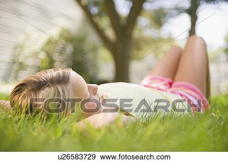 USA, New York, Girl (10-11) relaxing in park View Large Photo Image Stock Photo - USA, New York, Girl (10-11) relaxing in park. Fotosearch
