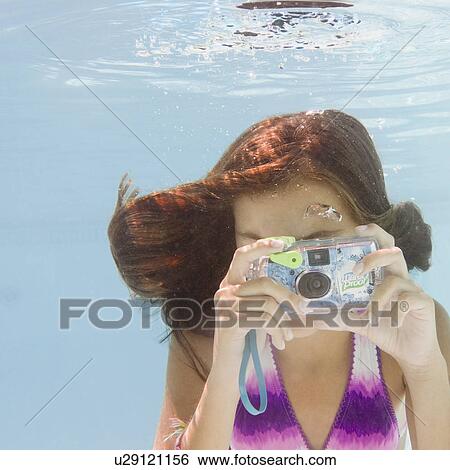 USA, New York, Girl (10-11) taking photo in swimming pool View Large Photo Image Stock Photograph - USA, New York, Girl (10-11) taking photo in swimming pool. Fotosearch