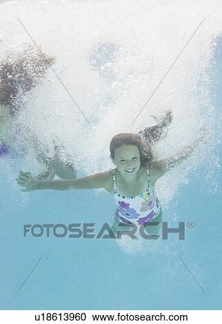 Stock Image - USA, New York, Girls (10-11, 10-11) in swimming pool. Fotosearch