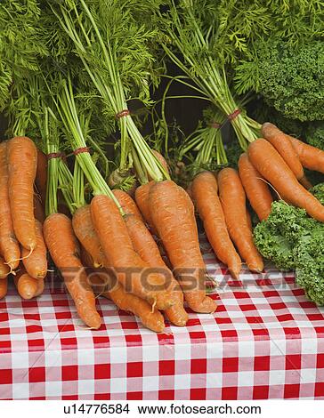 Picture - USA, New York, New York City, Bunches of carrots on farmer's market. Fotosearch