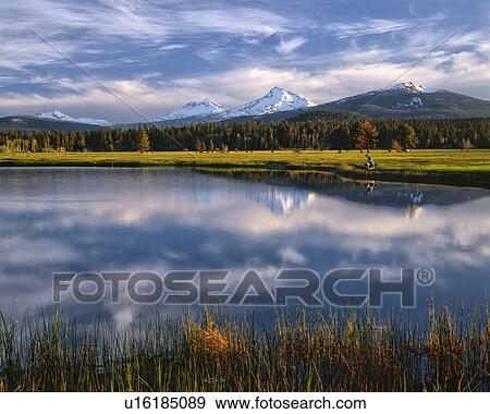 Stock Photo - USA, Oregon, Lake with Sisters Mountains in background. Fotosearch