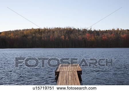 Stock Image - USA, Pennsylvania, Calicoon, Wooden pier at lake. Fotosearch