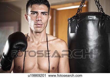 USA, Seattle, Portrait of young man in gym wearing boxing gloves View Large Photo Image Stock Image - USA, Seattle, Portrait of young man in gym wearing boxing gloves. Fotosearch