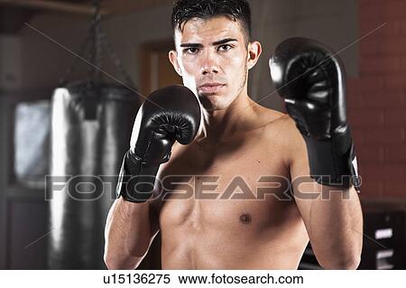 USA, Seattle, Portrait of young man in gym wearing boxing gloves View Large Photo Image Stock Photography - USA, Seattle, Portrait of young man in gym wearing boxing gloves. Fotosearch