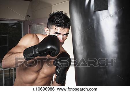 USA, Seattle, Portrait of young man boxing in gym View Large Photo Image Stock Photograph - USA, Seattle, Portrait of young man boxing in gym. Fotosearch