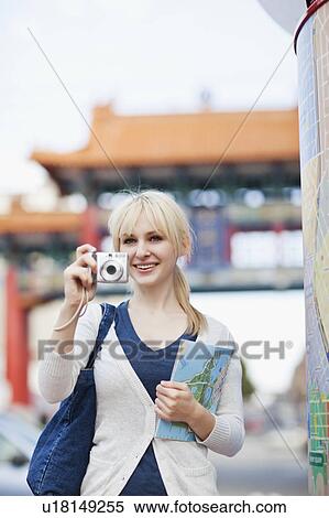 USA, Seattle, Young woman taking photos and holding map View Large Photo Image Stock Photography - USA, Seattle, Young woman taking photos and holding map. Fotosearch