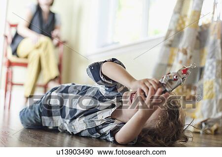 Stock Image - USA, Utah, Boy (2-3) playing on floor. Fotosearch